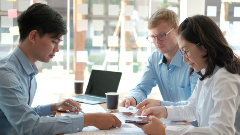 group of people at table discussions over paperwork